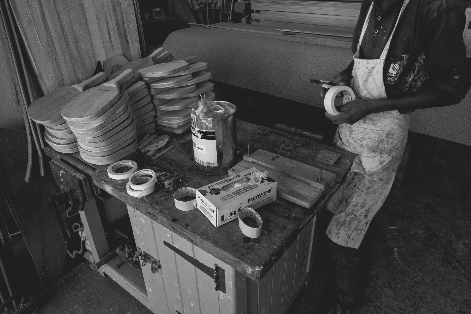 2022-02-14 - Cape Town - Man cuts masking take while constructing surfboard